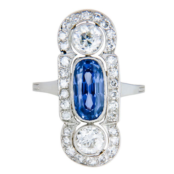 Wonderful Edwardian Platinum, Diamond and Sapphire Ring, set with an Oval-Cushion Ceylon Sapphire, approximately 1 carat. and further set with 2 old European cut Diamonds totaling .90 carat and surrounded by approximately 1 Carat of smaller old