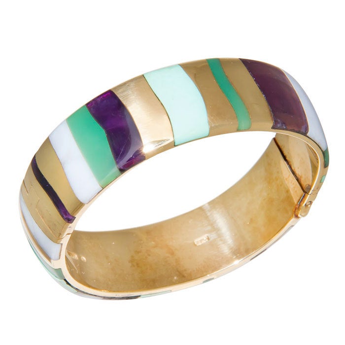 Tiffany & Company Circa: 1970s 18K yellow Gold Bangle Bracelet. Inlayed with Turquoise, Amethyst, Chrysoprase and Agate. Medium size.