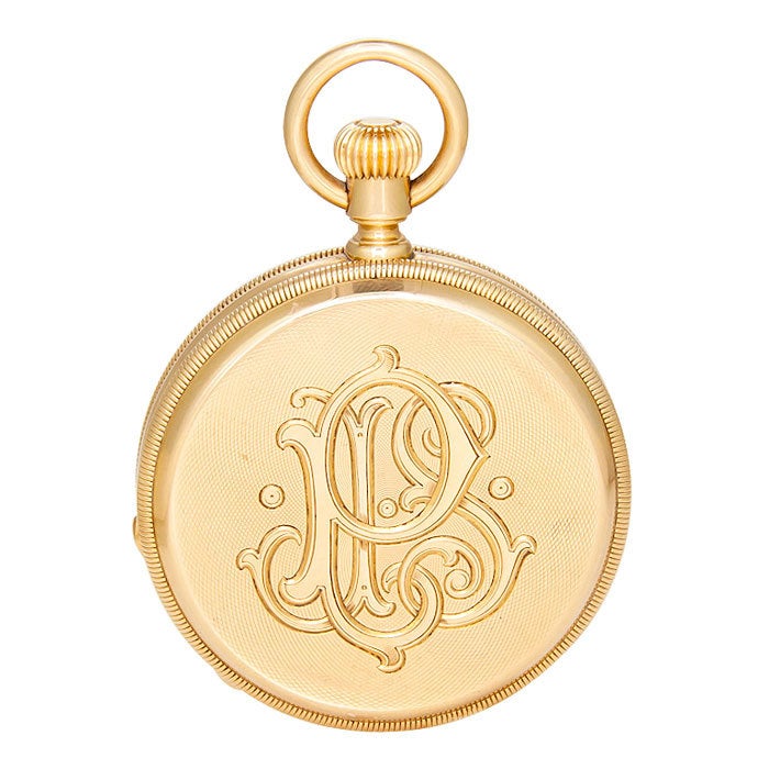 An 18K yellow gold 18-size demi-hunter cased pocket watch in an engine turned case. Porcelain dial, stem wound and set. Custom order case with original owner's name engraved on inside dust cover and Initials engraved on case back. 

Accompanied by