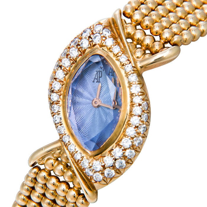Lady's 18k yellow gold Marquise shape wristwatch on a beaded mesh bracelet. Diamond-set pave case and faceted amethyst crystal, quartz movement.