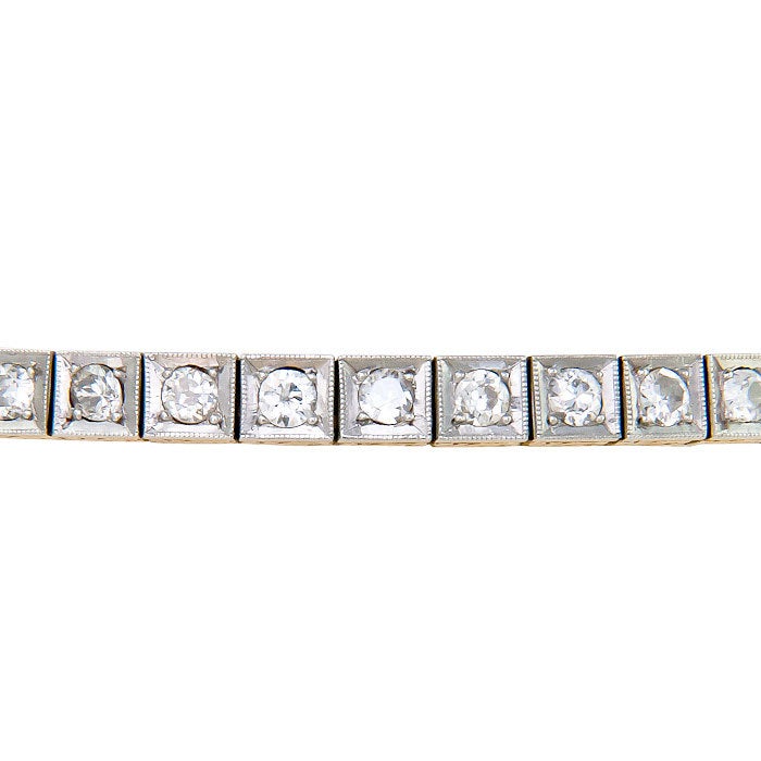 Circa: 1920s Platinum Top and Yellow Gold Back Diamond Line Bracelet. Set with Old European cut Diamonds totaling 3 Carats. Hand Engraved Design work.