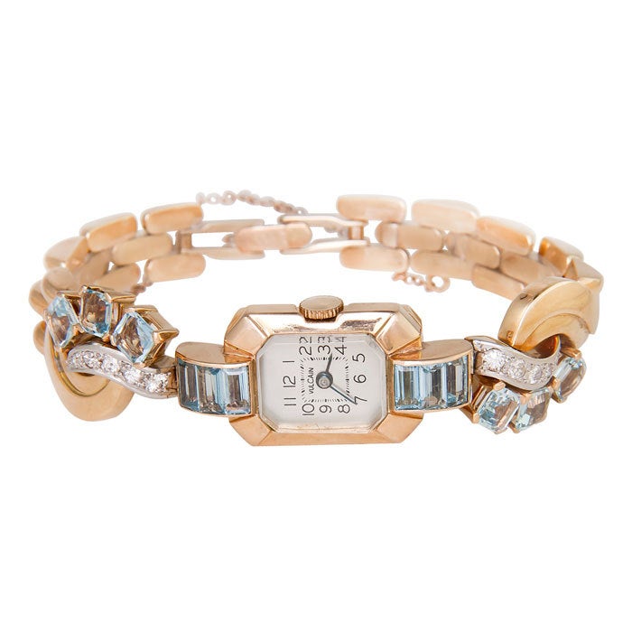 Circa 1940, 18k yellow gold bracelet watch, set with square, stepped cut and baguette aquamarines, further set with numerous diamonds. 17-jewel manual-wind Vulcain movement.