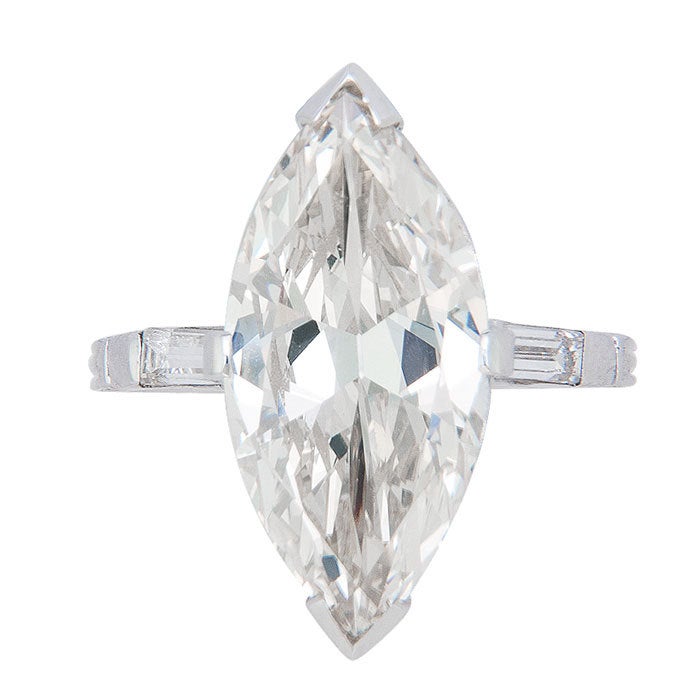 5.40 carat Marquis Diamond in a Platinum Mount, Circa: 1930, the Diamond measures 19.3 X 9.3 X 5.2 and Has a depth of 55.9% and a Table that is 67%. The Color is O and Clarity VVS1 Good proportion and showing Fluorescence. The Mounting is Platinum