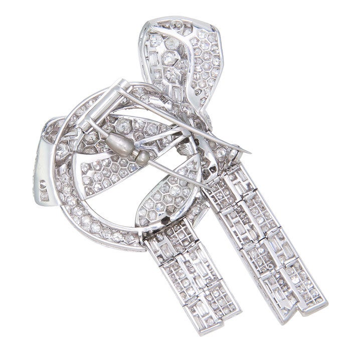 Large and Impressive, Circa: 1930 Ribbon and Bow Clip Brooch, with articulated ribbon sections. Set with 15 carats of Round and Baguette European and single cut Diamonds.