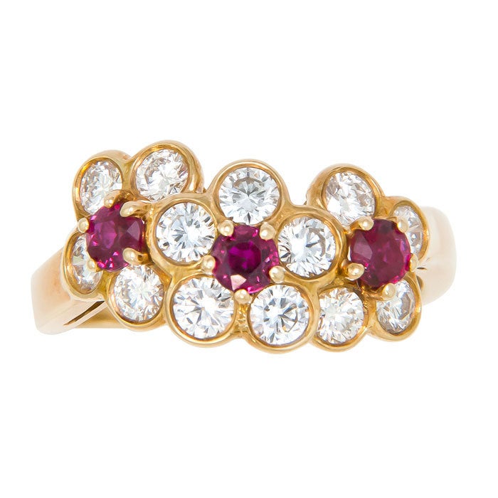 18K yellow Gold, Diamond and Ruby set 3 Flowers Form Ring by Van Cleef & Arpels, Diamonds total 1.04 Carat. Signed and Numbered, Finger size = 5 1/2 original Suede Pouch.
