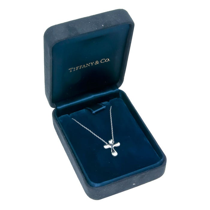 Platinum Cross Pendant on a Platinum Chain by Elsa Peretti for Tiffany & Co. Cross measuring 5/8 inch. With Original Tiffany Gift Box.