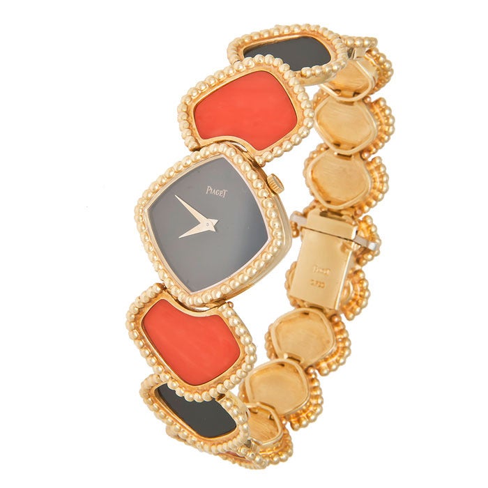 Outstanding Piaget lady's 18k yellow gold bracelet watch with Onyx dial and articulated coral and onyx bracelet, manual-wind movement. Case and bracelet signed Piaget. Circa 1980.