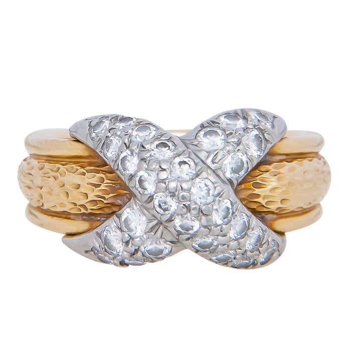 Circa: 1980 18K Yellow Gold, Platinum and Diamond set X Ring by jean Schlumberger Studios for Tiffany & Company. Set with Round Brilliant cut Diamonds Totaling 1 Carat. The ring also features a textured finish. Finger size = 7 1/2