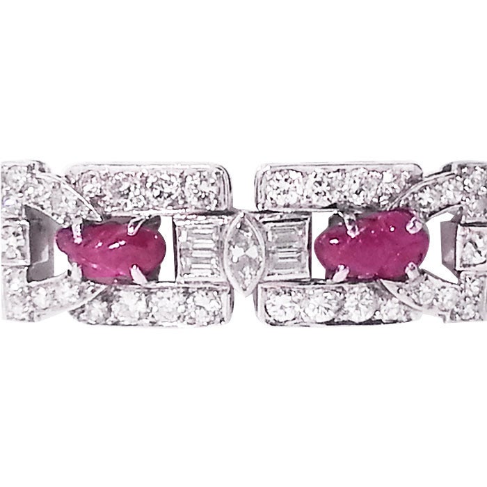 Circa: 1930s Art deco Platinum, Diamond and Ruby Bracelet by Waslikoff of New York. set with 6.50 Carats of Round, Marquise and Baguette Diamonds. Further set with Carved Cabochon Rubies.