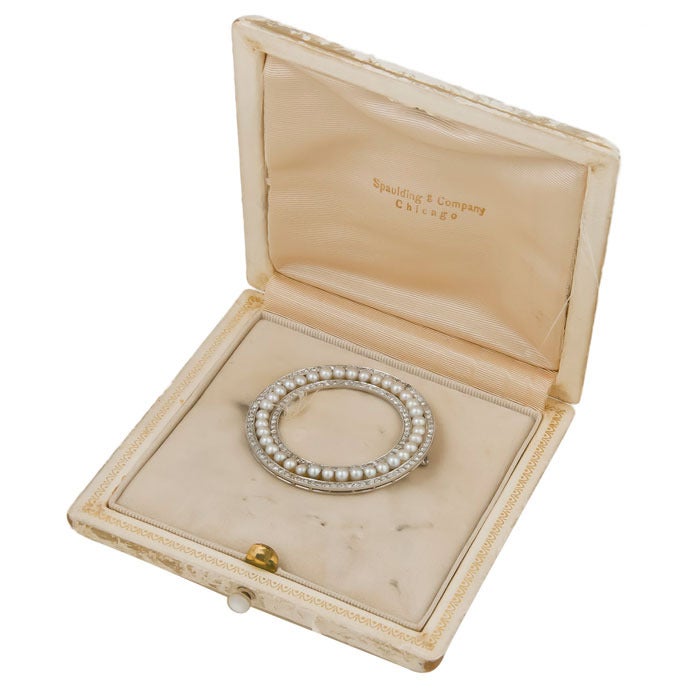 Circa: 1920s Large Platinum Circle Pin, set with 1.50 Carats of Old Cut Diamonds and 36  3 M.M. Natural Pearls. Comes in Spaulding and Company box, from the estate of the original owner who received most of their jewelry from Spauldings.