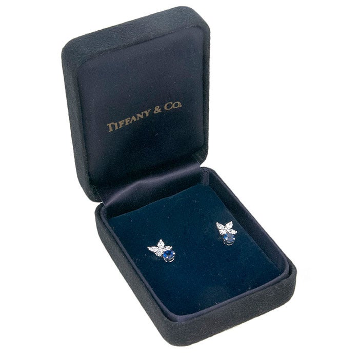 Tiffany & Company Earrings from the Victoria Collection, mounted in Platinum and set with Marquise Diamonds totaling .79 Carat that are G in color and VS in Clarity, further set with Round Brilliant cut Sapphires of very fine color. Post Backs.