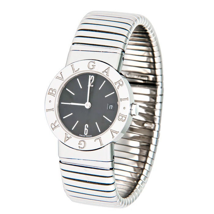 Bulgari lady's stainless steel Tubogas bangle bracelet watch, quartz movement, black dial with date window and sapphire crystal. adjustable, flexible bracelet. Comes in original box