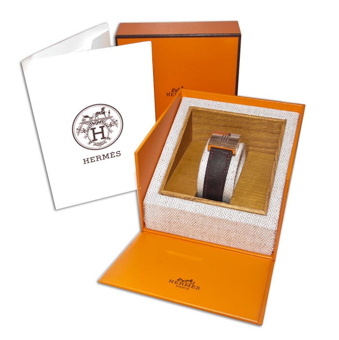 Hermes lady's 18k rose gold Glissade wristwatch, mother-of-pearl dial, quartz movement, leather strap with gold buckle. 

Comes with original box and the original sales receipt from 2005 for $5275.00. Strap still has some wear left but will need