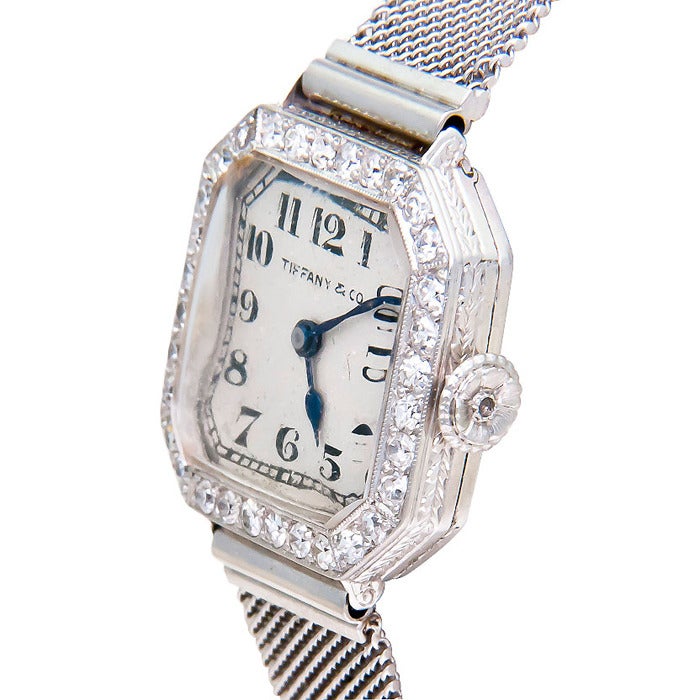 Platinum and diamond lady's wristwatch by Patek Philippe, retailed by Tiffany & Co., circa 1920s. 18-jewel manual-wind movement. Matching case and movement serial numbers. Adjustable Platinum mesh bracelet. 7/16 inch wide, diamond-set bezel, buckle