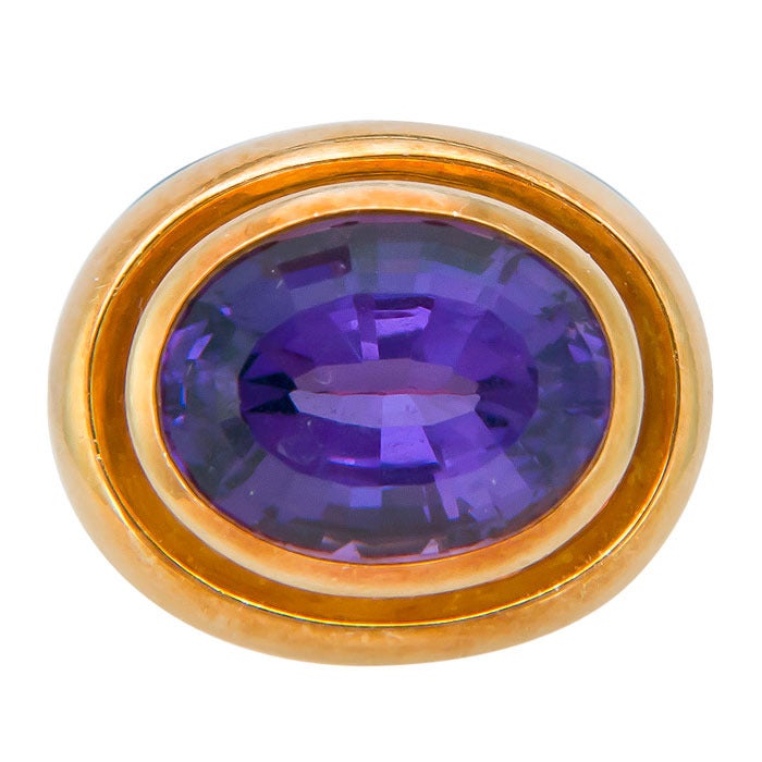 Circa 1980s 18K Yellow Gold Ring by Paloma Picasso for Tiffany & Company, Centrally set with an oval step cut Amethyst of very fine Deep Rich Purple Color of approximately 6 carats.  Finger size = 6 1/2