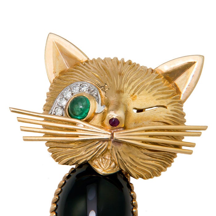Circa: 1960s Winking Cat, clip Brooch by Van Cleef & Arpels, this being the larger two inch Brooch of the two sizes they produced. Hand made and nicely detailed with Onyx Body, Emerald Eye. Ruby Nose and Diamonds Eye Lid. Signed, Numbered and with