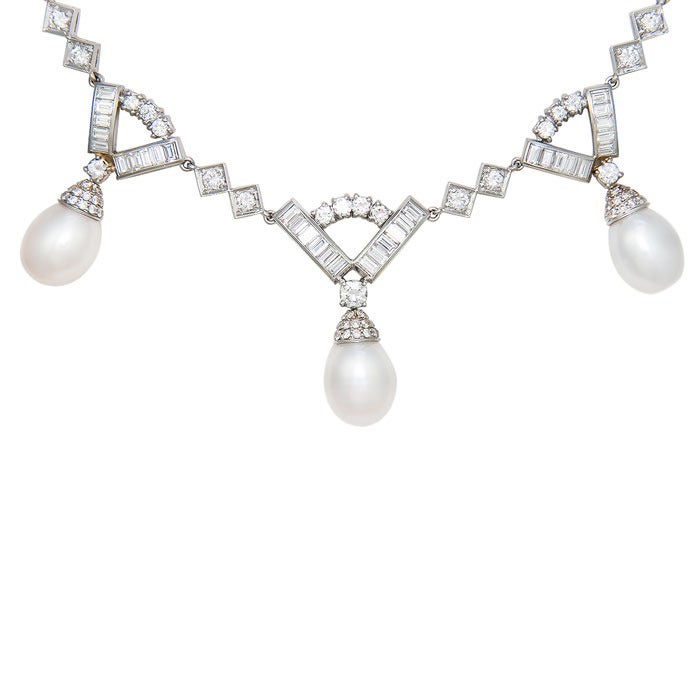 Very Elegant circa: 1960s Platinum Necklace set with 10 Carats of Round and Baguette Diamonds. and 5 Pearls each measuring just over 10 M.M. Every Link is attached separately to the sections so that this Necklace is flexible and has great movement.