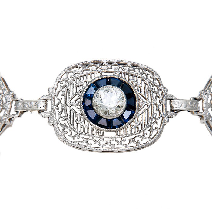 Circa: 1920s Platinum Top, Gold Back Filigree Bracelet, set with 2.50 Carats of European cut Diamonds that are white and very clean. Also set with 2 old Cushion cut Rubies that are of Beautiful Blood Red Color and further set with Faceted Sapphires
