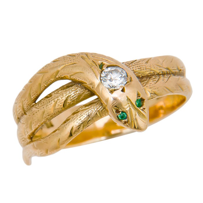 Circa:  1910 18K yellow Gold, Coiled Snake Ring, set with a European Cut Diamond approximately .20 carat and emerald Eyes.  Finger size = 9 1/2