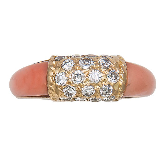Circa: 1980s Van cleef and Arpels 18K Yellow Gold and Angel Skin Coral Ring. Diamonds total approximately .50 carat. Signed and Numbered, Finger size = 4