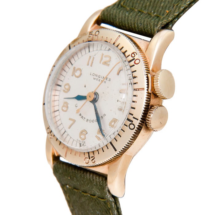 Longines 14k yellow gold Weems pilot's wristwatch, 27mm. 17-jewel manual-wind movement, rotating bezel with bezel lock crown. Original silvered dial with raised Arabic markers, sweep seconds. Green military strap.