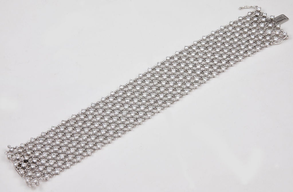 A bracelet that is so flexible it feels like silk, this 18k white gold piece designed and exquisitely crafted by Valente is set with 16 carats of great quality diamonds. The bracelet closes with an 