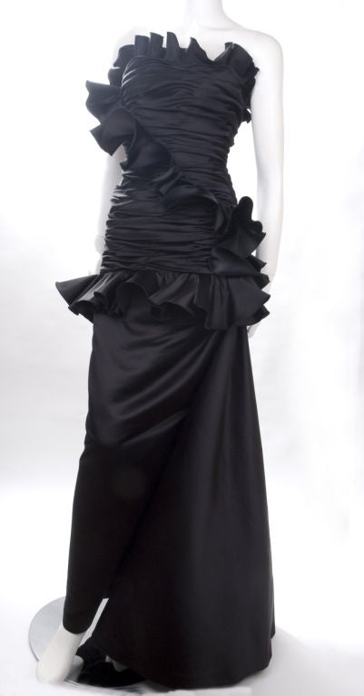 Victor Costa Black Satin Evening Gown.
Built in boned bodice, zips up on the left, black tulle supports the drape volume.
Excellent condition-  no flaws to mention.
Size: US 8
Measurements:
Length 51 - bust 38 - waist 31 - hips 40 inches

