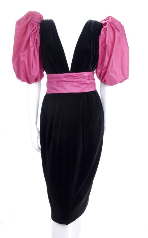 1984 Yves Saint Laurent Cocktail Dress.
Black velvet with pink taffeta silk sleeves and belt.
Pockets in the side seam.
Size 38 EU about 6 US

Measurements:
Length 41