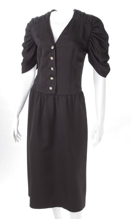1981 Chloe Black Silk Cocktail Dress.
Rhinestone buttons with gilded frame.
Pockets in the side seam.

Measurement:
Length 47