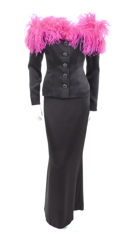 Yves Saint Laurent Black Satin Off Shoulder Evening Suit with Pink Feathers.
The jacket is elastic around the shoulder and keeps it perfectly in place.
Godet skirt and the jacket with black jet-stone buttons.
Size 40 EU - 
Measurements:
Jacket