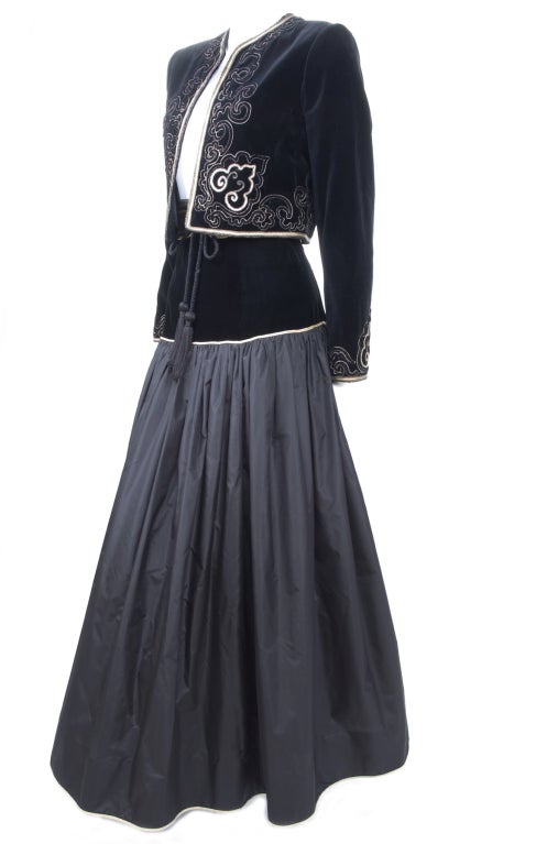 Yves Saint Laurent Evening Taffeta Skirt with Bolero Jacket
The velvet bolero is embroidered with gold piping and stitching.
Matching suede belt with gold piping and tassels.
The Skirt with velvet to the hip, two layers of taffeta silk and gold