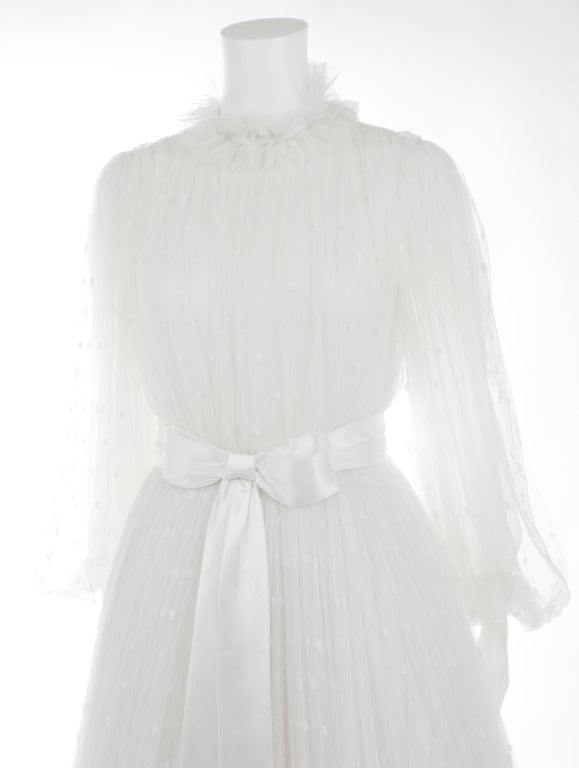 Vintage 1970's Jean-Louis Scherrer Calais Lace Wedding Gown.
The lace pattern starts with dots and from knee high in a floral band around the bottom. A asymmetrical five layer underskirt in cotton cheese cloth, gives the right volume to the