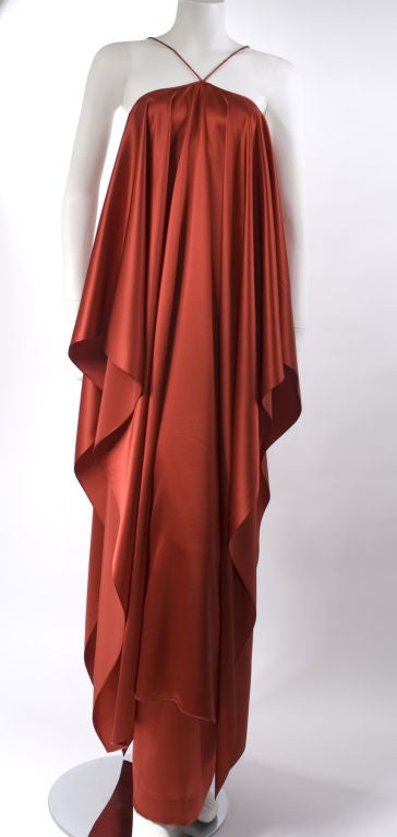 Mid 70's Yves Saint Laurent Haute Couture Gown in red satin silk.<br />
This is a Patron Original Dress this is the one he work on himself, this dress was shown on the runway.<br />
Only Yves Saint Laurent labeled it this way.<br />
Skirt with a