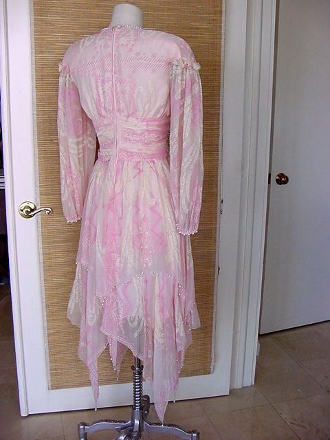 **Buyer MUST contact me prior to purchase for shipping and payment requirement details.
mad4couture@gmail.com**
Coveted designer ZHANDR RHODES rare vintage dress in soft shades of pink and winter white.
Layers of hankercheif hem.
The top layer