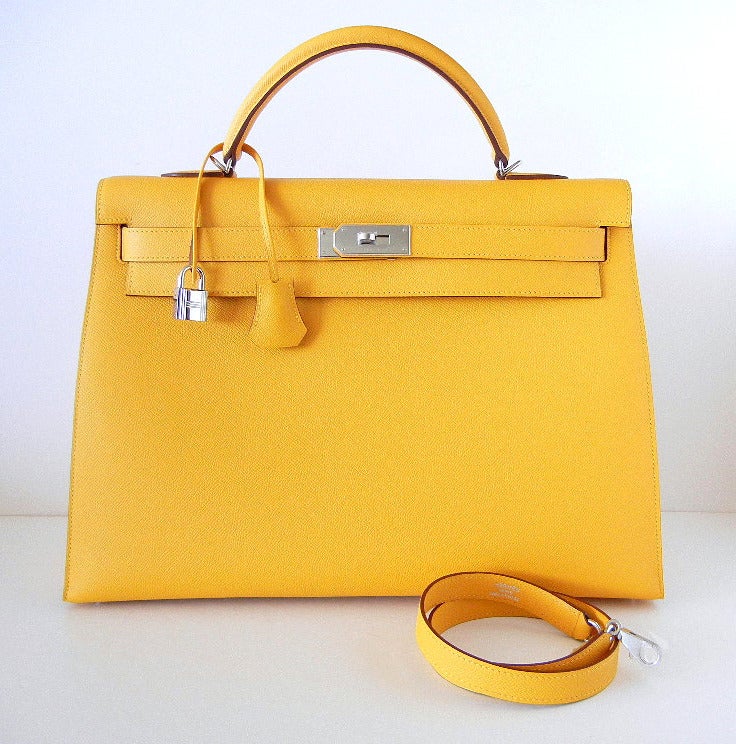 A TO DIE FOR beauty that is SO exquisite, rare, and utterly breathtaking! 
This rigid Kelly is in the rare coveted colour SOLEIL.  
The ultimate neutral and perfect year round colour.
VEAU TRACKING is the new leather from HERMES and combines the