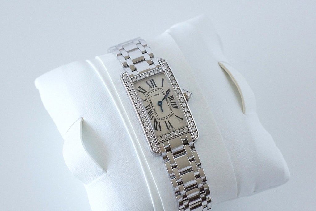 Fabulous Cartier Tank Americaine 18k white gold watch with original factory-set diamonds. 
Deployant buckle. 
Comes with 3 extra links. 
Comes with Cartier booklets: certificate of guarantee, red Cartier gift box and outer box.
All markings are