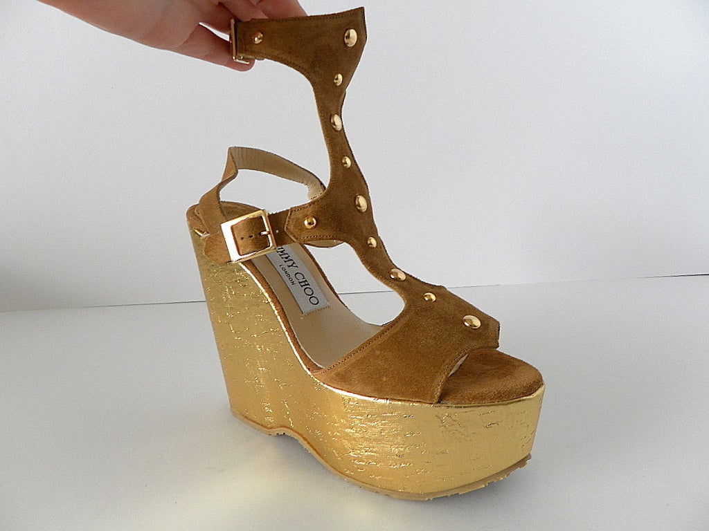 High suede ankle strap and slingback have gold stud detail.
Open toe with shaping.
WOW! 
Light weight for super comfort.  
BRAND NEW. NEVER WORN. 
Comes with box and sleeper. 
more pictures available upon request
final sale

SIZE  36 1/2