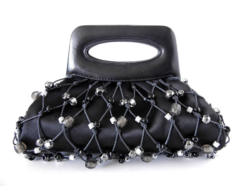 **Buyer MUST contact me prior to purchase for shipping and payment requirement details.
mad4couture@gmail.com**
The MOST charming evening bag. 
Black leather cut out frame handle with a black satin body. 
The body has black diamond shaped cord