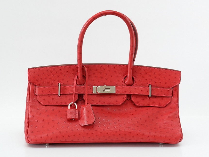 Drop dead fabulous!  The ORIGINAL JPG Shoulder Birkin.
Rare in ostrich, even more rare in coveted Rouge Vif.
Accentuated with the Palladium hardware and pink stitching!
A terrific play on the hardware and shape makes this bag a standout