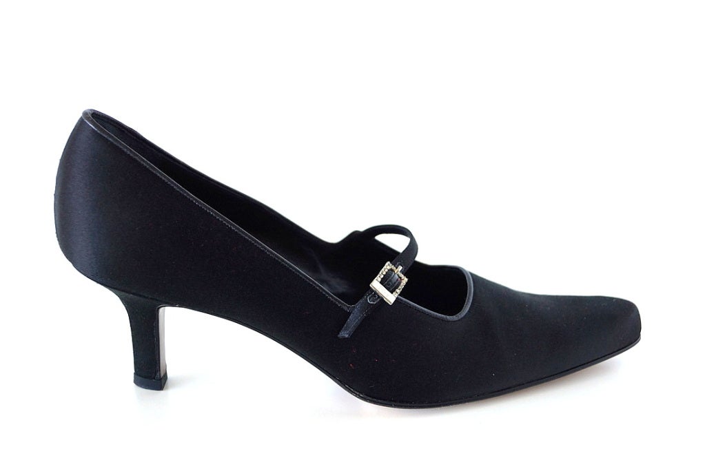 Beautiful cut and style define the body of this black satin shoe. 
Mary Jane style strap across with front with a small rectangular diamante buckle.
Beautiful shape of the heel. 
Worn one time only! 
more pictures available upon request
final
