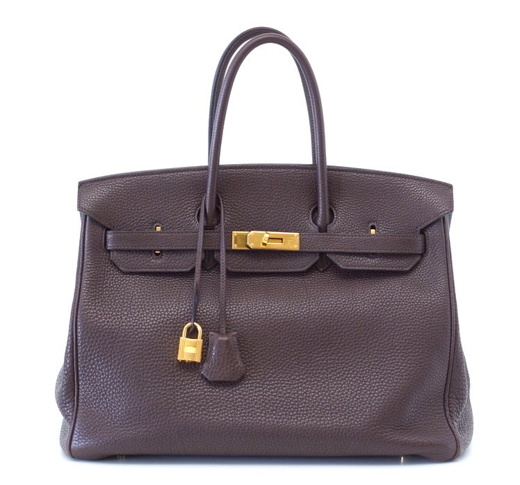 Rich chocolate brown with gold hardware.
The rich and coveted TOGO leather is textured to be highly scratch resistant.
Clean corners, handles and interior.  Just had a loving spa at Hermes.
Natural wear marks on the gold hardware.
Comes with