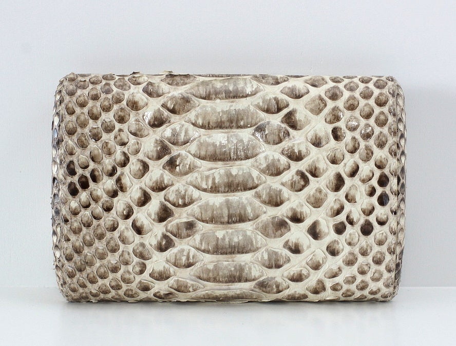 Fabulous python hard frame clutch in shades of taupe and creamy white. 
Gorgeous skin. 
Interior is creamy white satin with NANCY GONZALES, GENUINE PYTHON embossed inside. 
Simple chic and wearable. 
Comes with sleeper.  
more pictures
