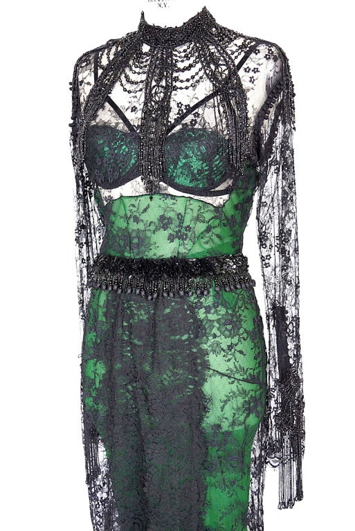 2011 RTW Black Chantilly lace dress with emerald green silk chiffon under pinning.
Exquisite bead and paillette work at neck, cuffs and waist. Small buttons don the back, up the cuff all with hidden zippers for easy access.
Small buttons around
