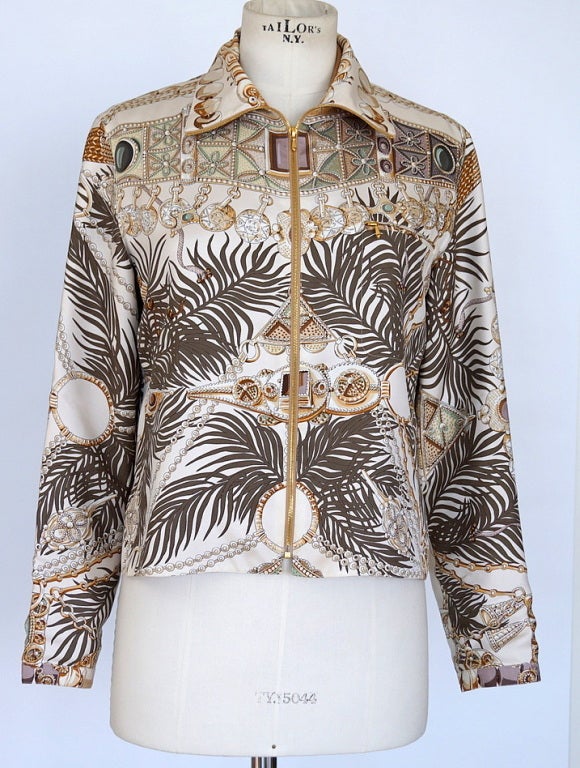 Guaranteed authentic Hermes scarf print jacket that is sublime.
Gold hidden zip front jacket. 
Beautiful intricate design of leaves and jewels in golds, browns, shades of greens and lavenders.  See detailed pictures.
Signed Annie Faivre on
