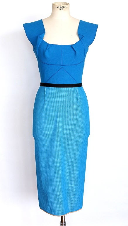 Fabulous  robins egg blue dress with divine style and cut.
The lower portion of the dress is a unique sort of braided pattern with the blue set atop a soft silvery gray.
Beautifully shaped neckline in front and back.
Sleeveless with architectural