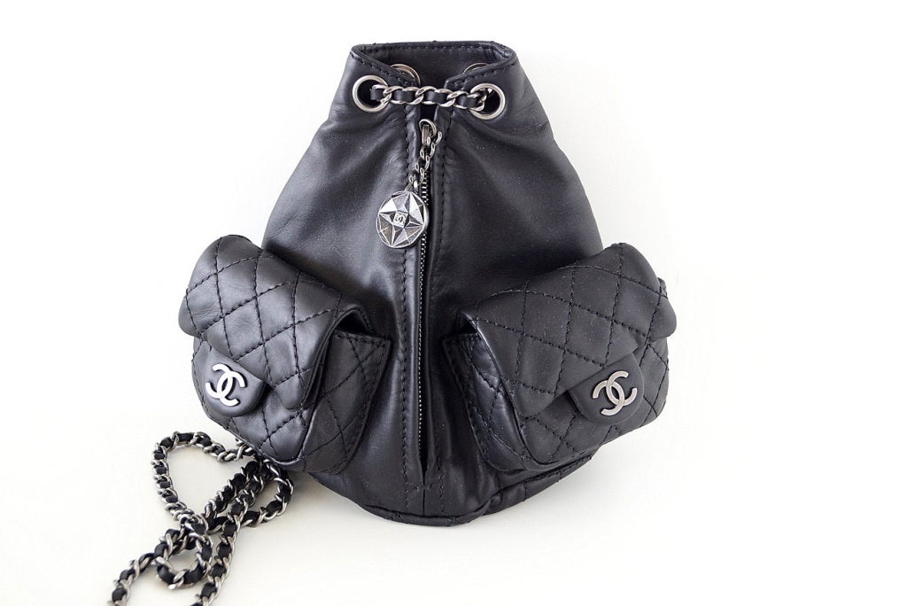**Buyer must contact me prior to purchase for shipping and payment requirement details.
mad4couture@gmail.com**
A most divine petite black leather backpack that is sooooo charming!
Triangular shape with 2 quilted flap pouch pockets on the