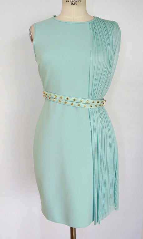 Guaranteed authentic VERSACE unique dress.  
Soft sea foam blue green round neck sleeveless dress.
Unique fabric has body.
Straight cut with seam at waist.
Comes with 2 thin leather belts with gold studs.
From shoulder to hem on one side dress