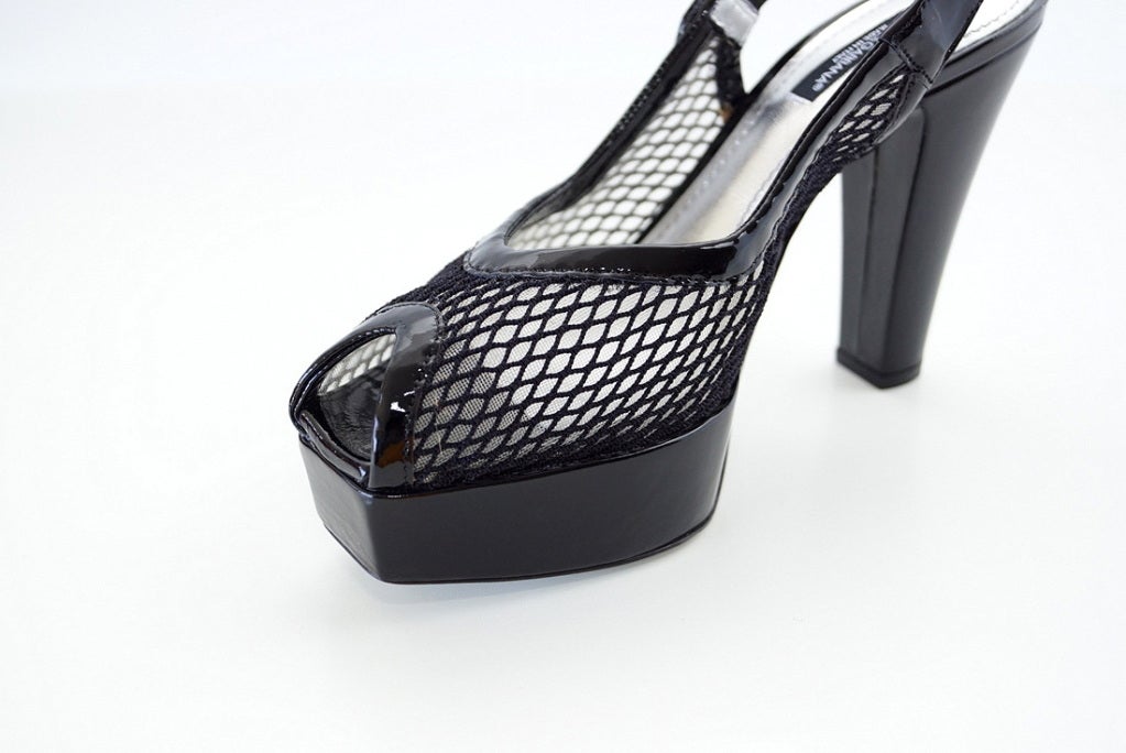 Guaranteed authentic DOLCE&GABBANA jet black patent and net platform shoe styled in true DOLCE form! 
The platform has a blunt, squared off, finish at the front.
The body of the slingback shoe is black netting, edged in black patent