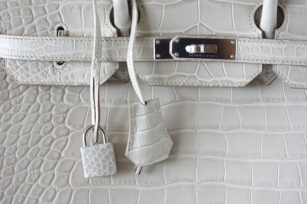 Beautiful chic BETON (concrete) in matte Alligator.
The lightest color available next to white.
With palladium hardware - simply exquisite. 
So supple and soft.
NEW or NEVER WORN.  
Comes with lock, keys, clochette, sleeper, signature HERMES box.