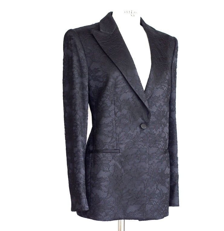 Beautifully shaped tuxedo style jet black lace jacket.
Peak lapel, 1 button single breast.
2 slit pockets still sewn shut.
Cuffs have a 2